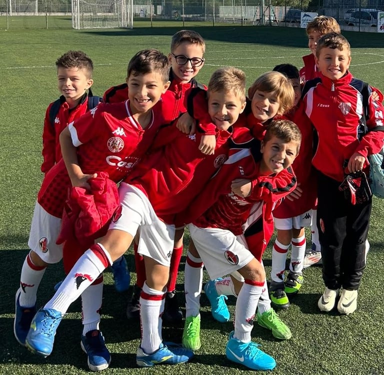 a group of young children soccer players posing for a picture