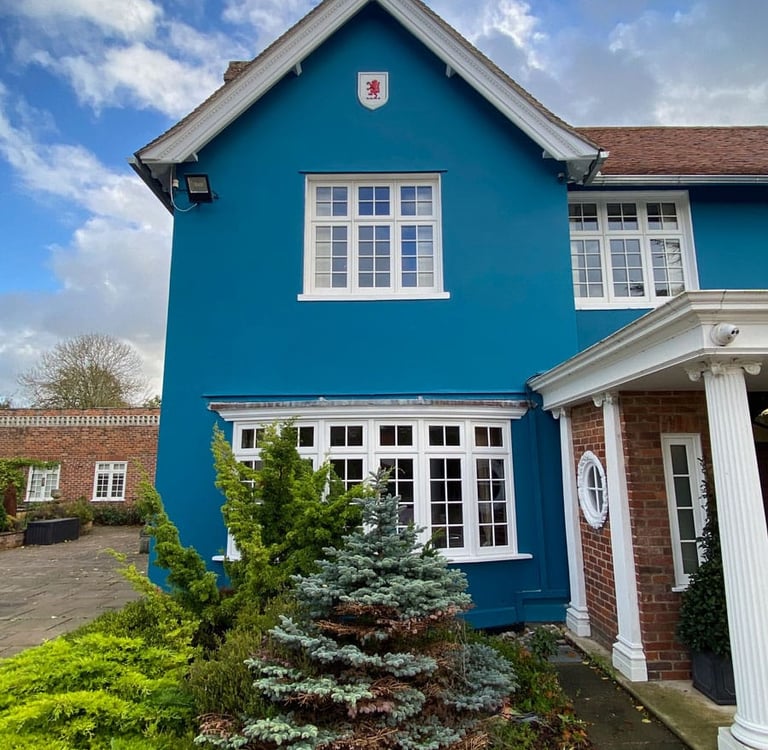 Frontal view on blue villa with red lion rampant in a painted white shield.