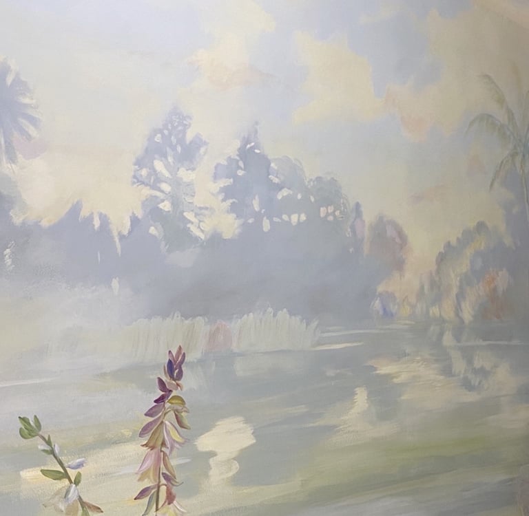 Hand-painted landscape mural with lagoon and trees on interior staircase wall