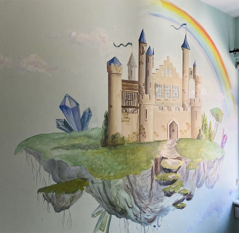 Kid's mural of a magical castle with crystals, a rainbow and white clouds