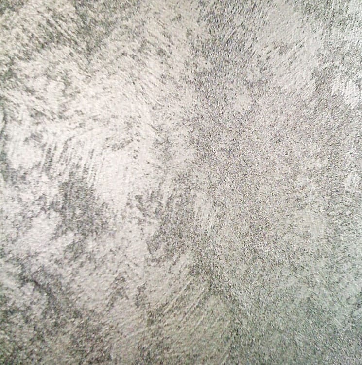 A cool silver paint sample showing off its shimmering grainy texture.
