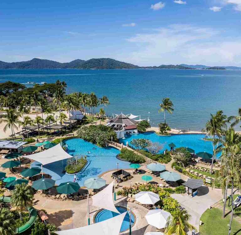 Swimming pool by the sea at Shangri-la Tanjung Aru Beach Resort