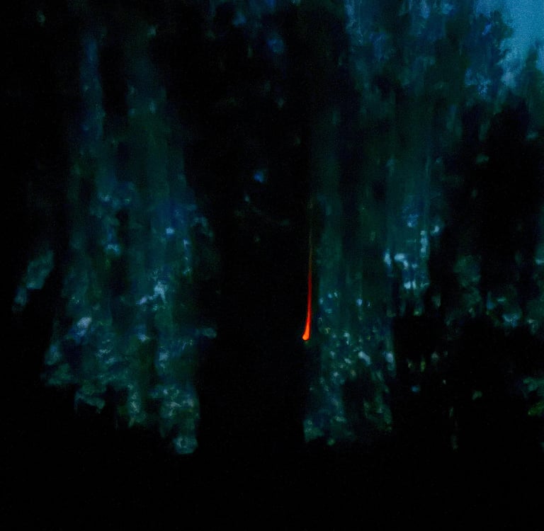 Cars parked on a narrow residential city street lined with historic brick apartment buildings.