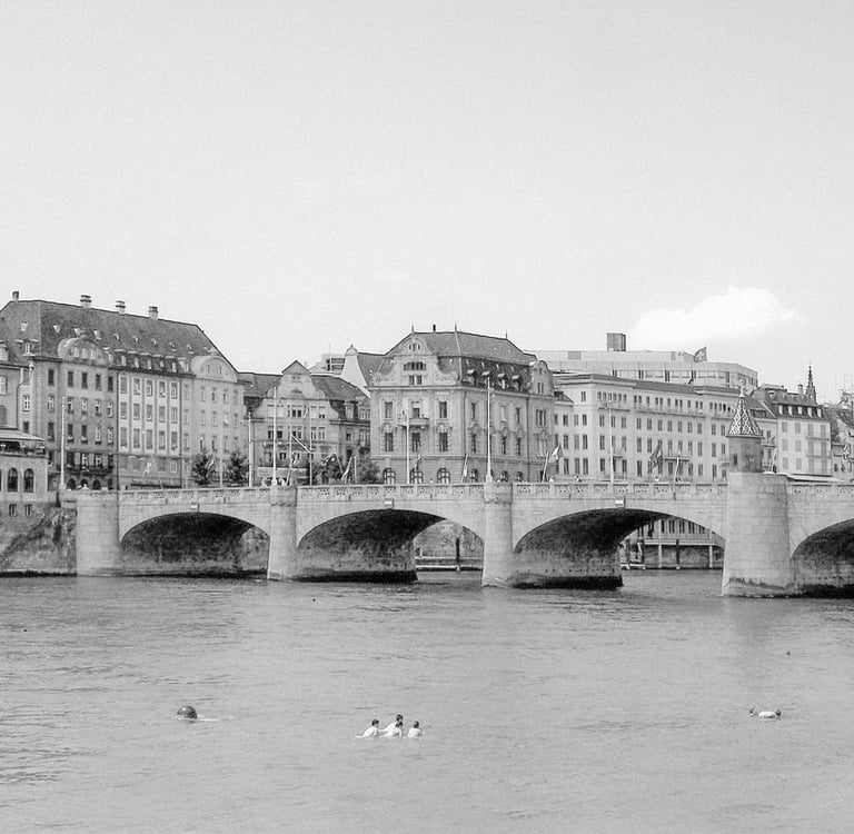 a bridge spanning over a river with several people