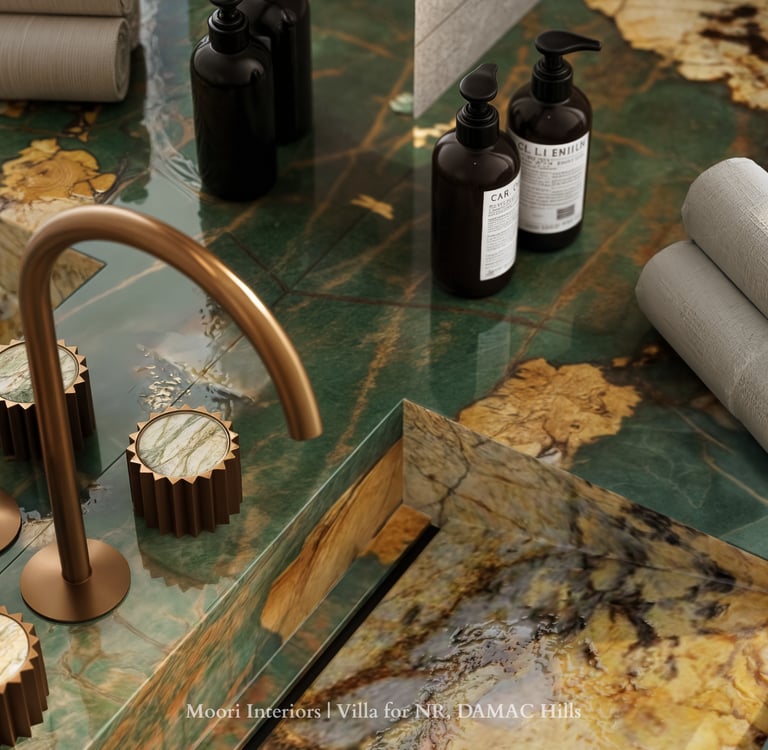 Close-up of a Green marble countertop with gold faucet and accessories in a modern bathroom.