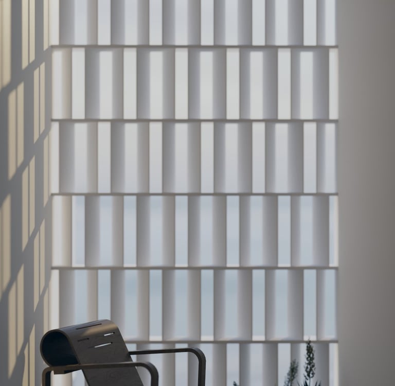 Sunlit reading nook with a sculptural black lounge chair and textured privacy screen