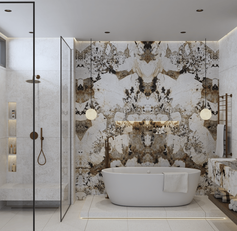 Luxurious bathroom with a white freestanding bathtub against a Patagonia Marble wall.