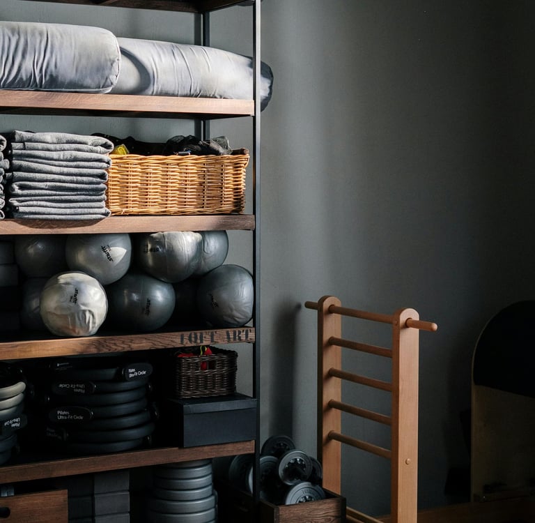 Dark open shelving storage with folded linens and organized home essentials