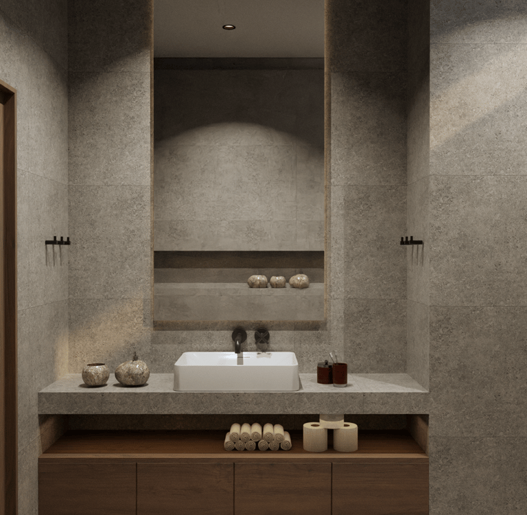 Modern bathroom featuring stone tiles and a large illuminated mirror.