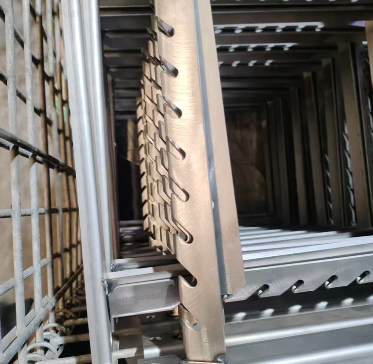 Stacked industrial stainless steel shelf supports with notched adjustment slots in a storage rack.