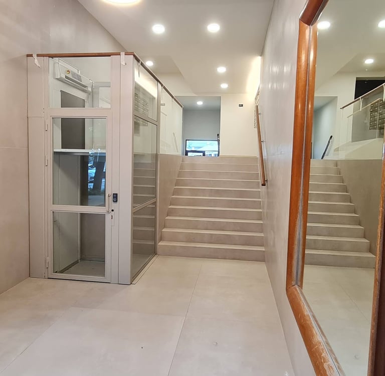 Renovated building entrance with platform lift and elevator, Anne apartment San Sebastian