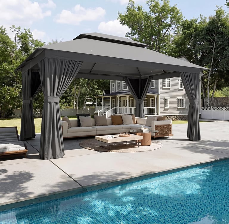 Modern grey outdoor gazebo with curtains over a poolside patio lounge area and sectional sofa.