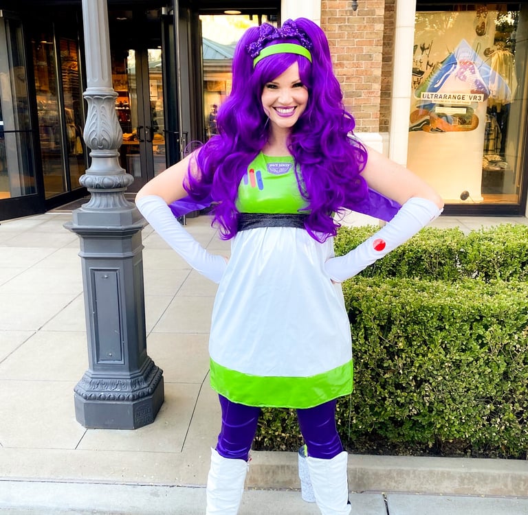 Woman  with a purple wig posing outside a store.