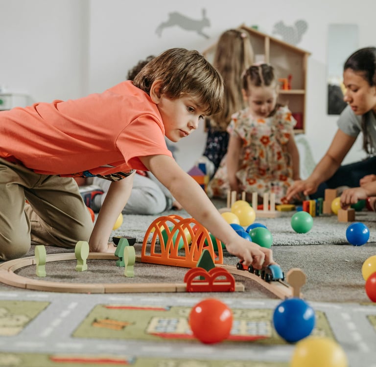 Speech therapist providing play-based therapy with a group of school-aged children.