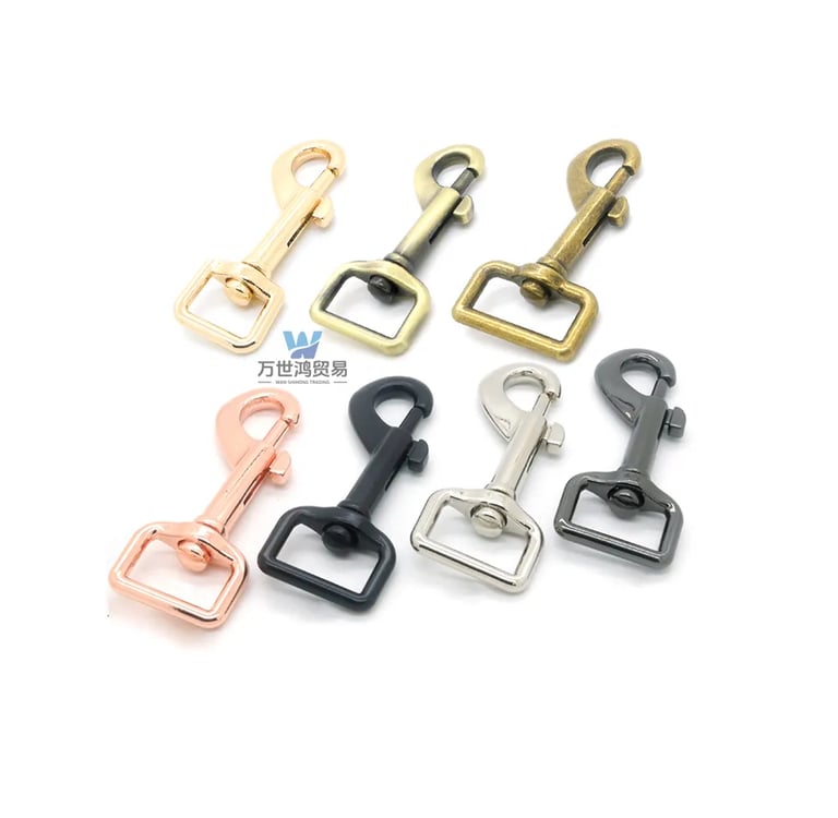 A collection of colorful swivel snap hooks for bag straps in gold, bronze, and silver finishes.