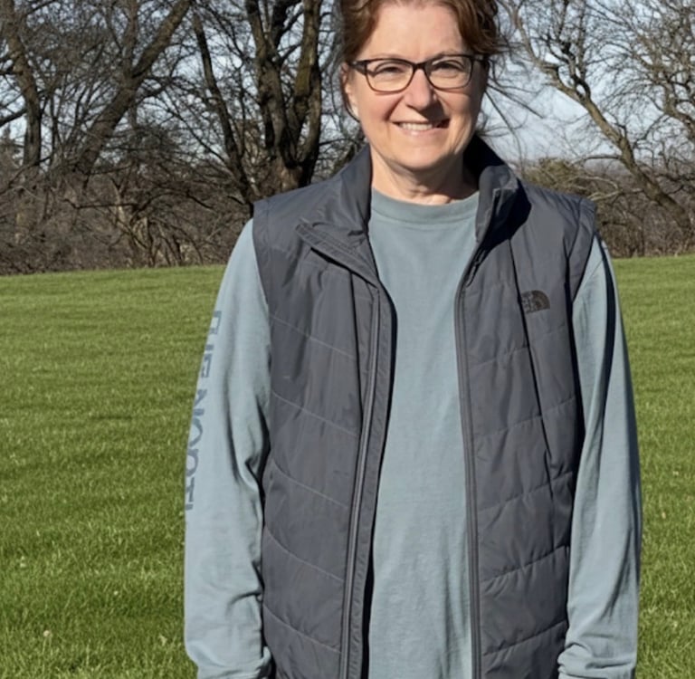 Farm owner standing alone in the field.