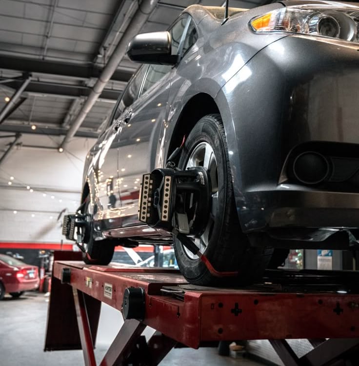 car undergoing wheel balancing and alignment