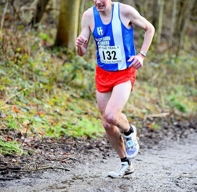 a man running on a trail in the woods