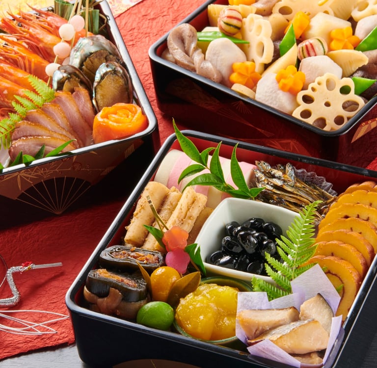 Traditional Japanese Osechi Ryori New Year food served in tiered lacquered bento boxes.