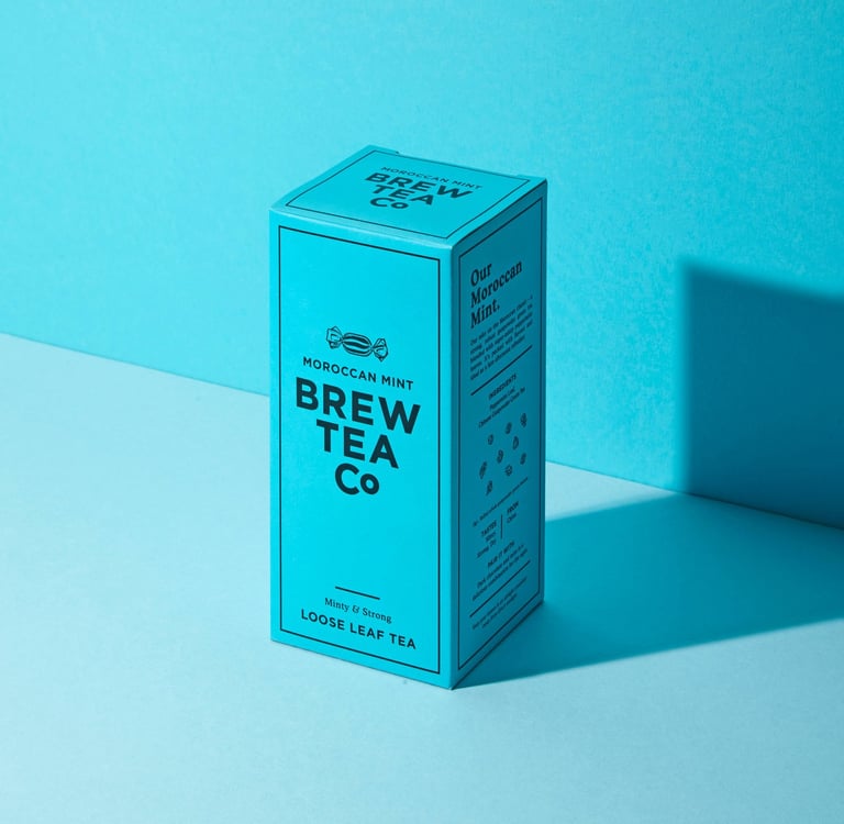 graphic Moody product photography of Brew Tea Co Moroccan Mint loose leaf tea box illuminated in coo