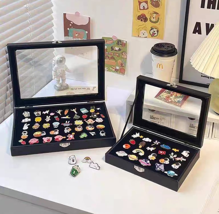 Enamel pins shown at different sizes for scale