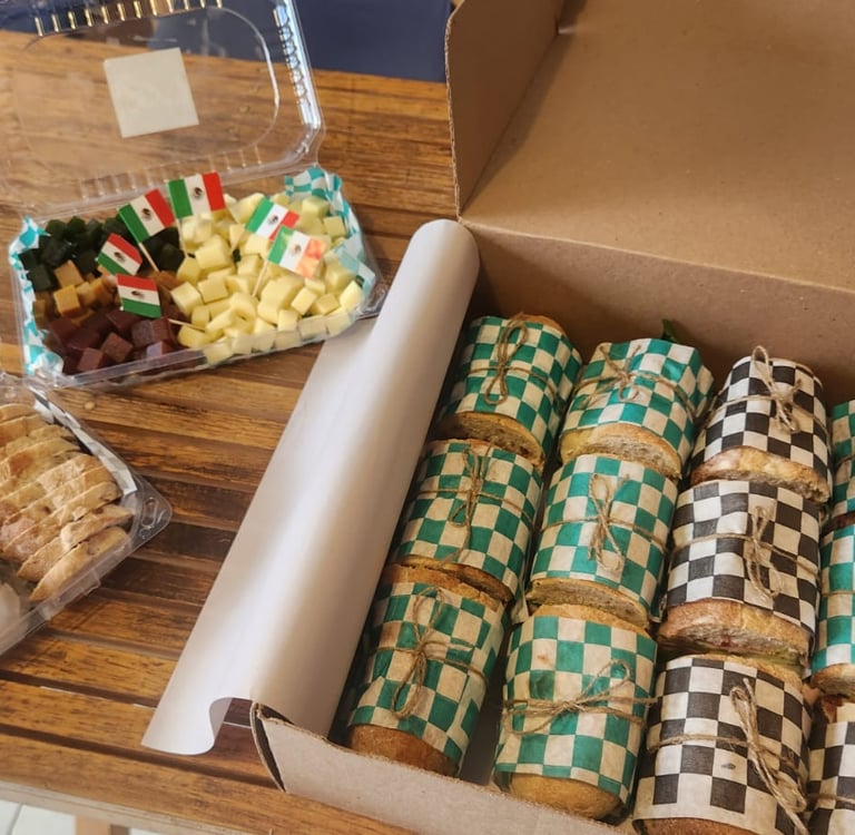 a box of cheese and a box of baguettes for catering
