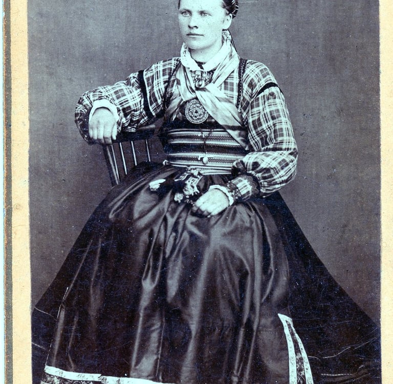 A black and white image circa 1890s of a woman in traditional dress