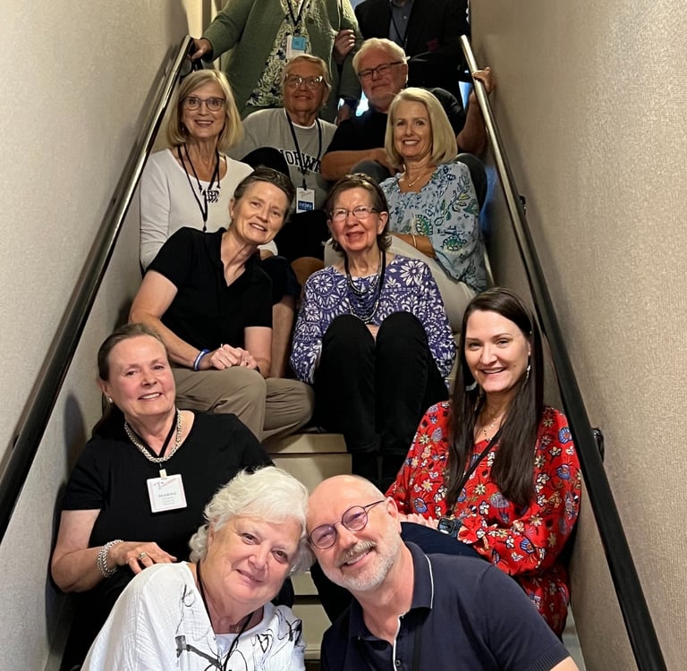 twelve Telelaget members sit in a stairwell