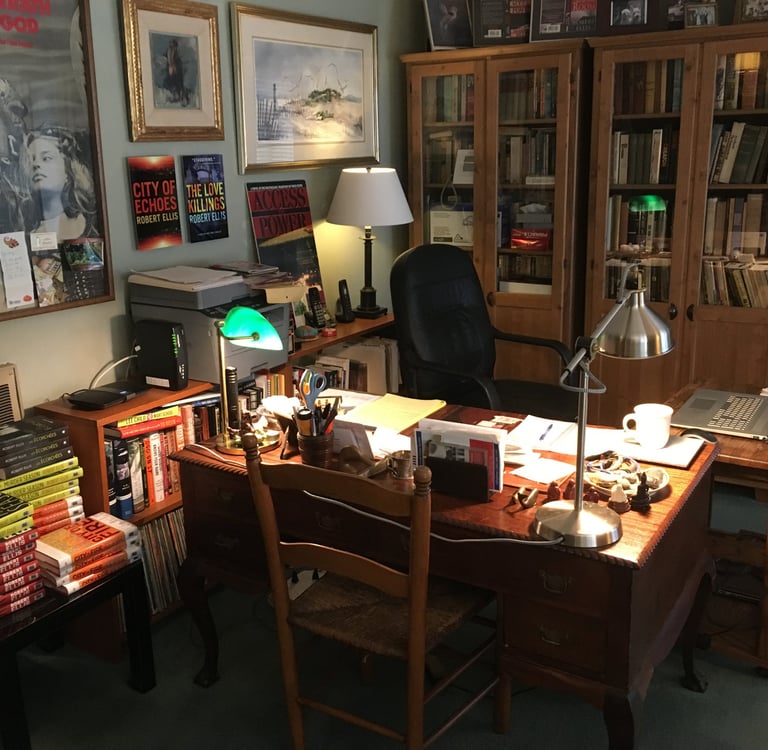 Photo of Robert Ellis's writing space with bookshelves in the background and art on the walls.