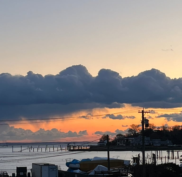 Photo of a serene sunset over Black Rock Harbor on Long Island Sound where Robert Ellis now lives. 