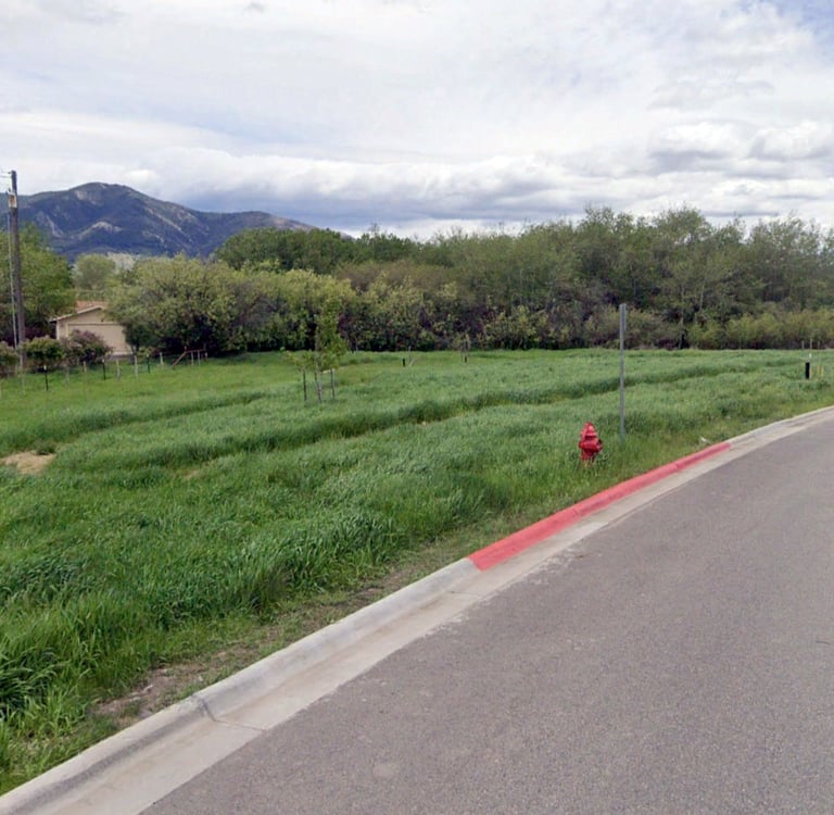a red fire hydrant sitting on the side of a road