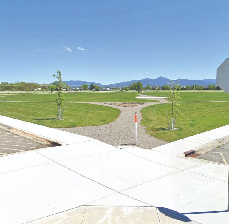 a stop sign on a street corner with a view of mountains in the background