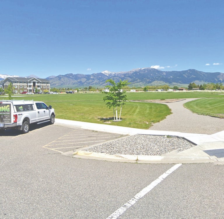 a van parked in a parking lot with mountains in the background