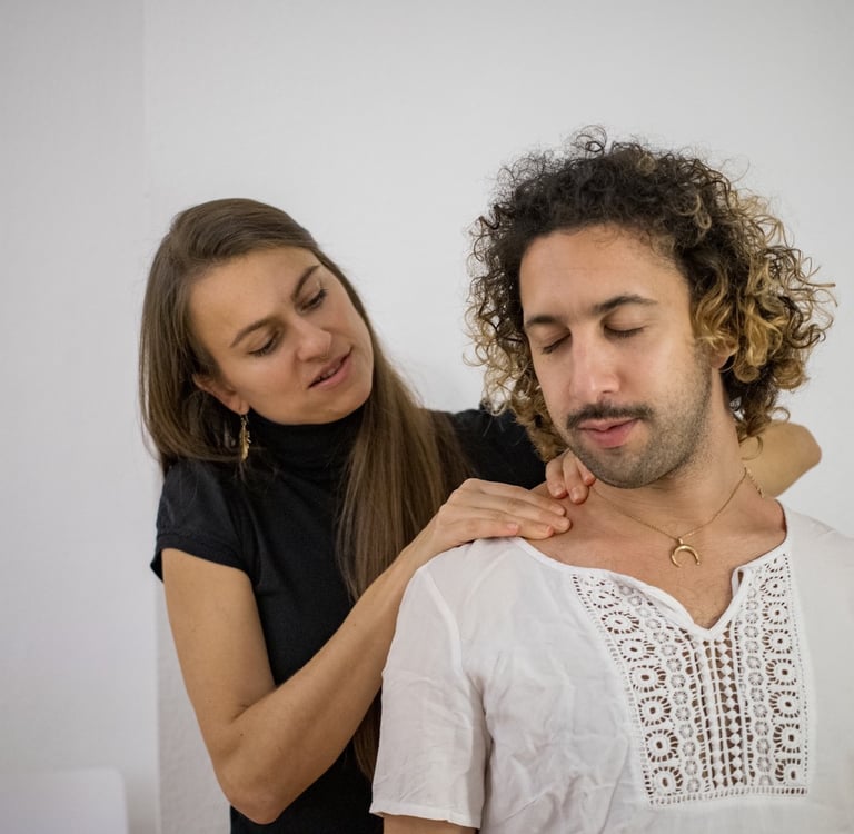 woman massaging mans shoulders