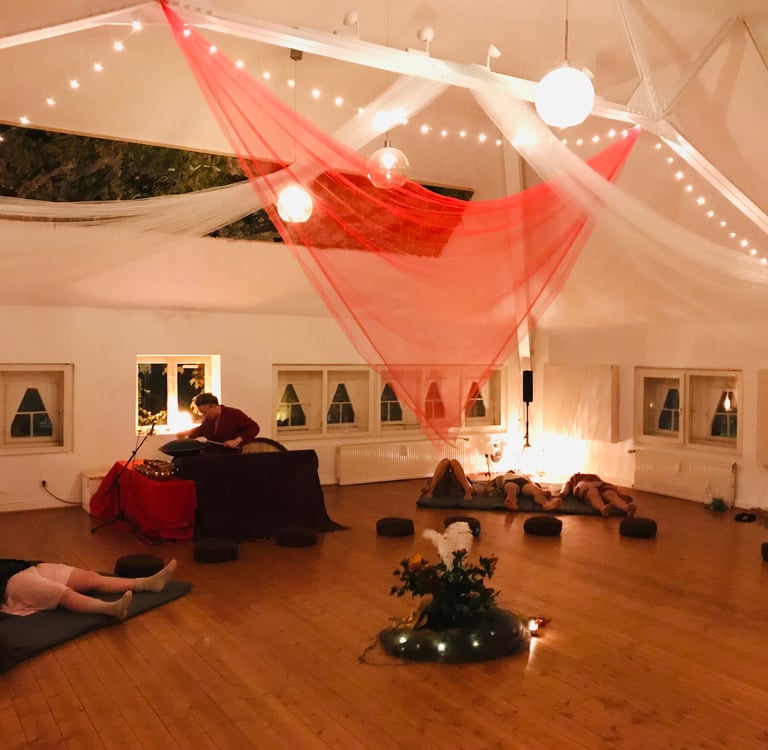 a room with a lot of people sitting on the floor