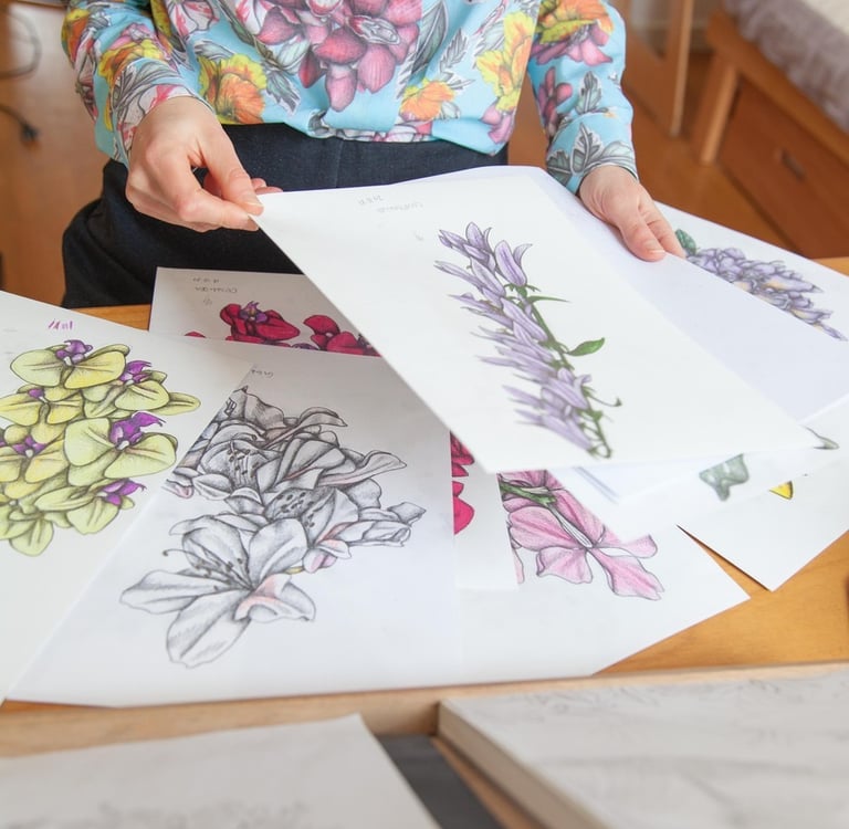 A desk filled with botanical illustrations
