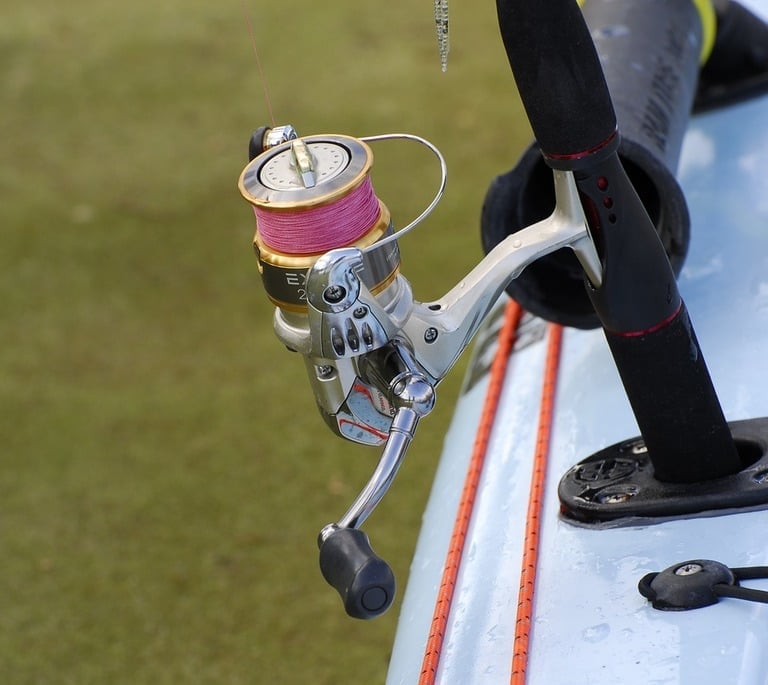 a fishing reel with pink fishing line