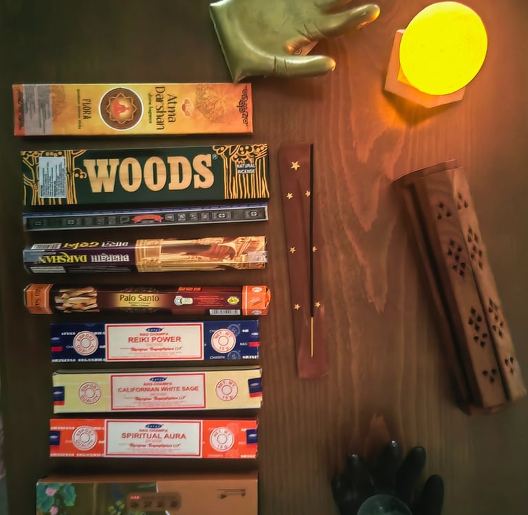 a table with a set of different flavoured incense sticks  and incense holders