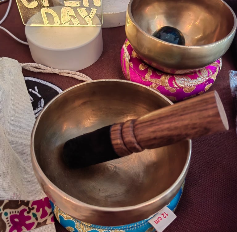 a metal bowl with a wooden spoon and a wooden spoon