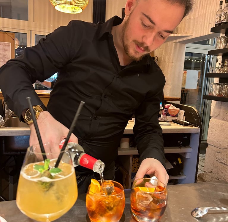 a man in a black shirt is preparing to serve a drink