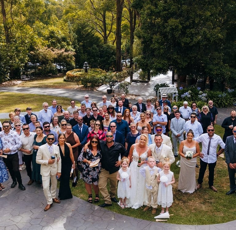 Large family group photo at Avalon Castle Melbourne wedding outdoor garden