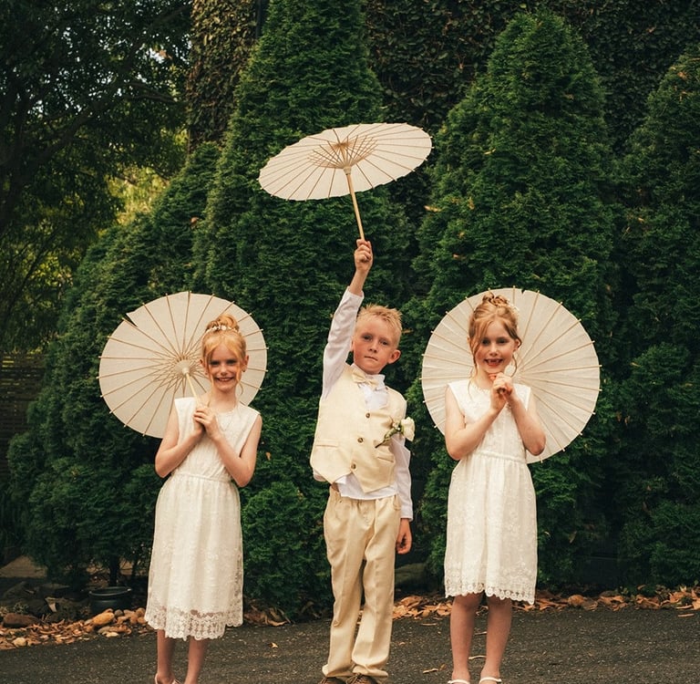 Children holding parasols at Avalon Castle Melbourne wedding outdoor ceremony momentChildren holding