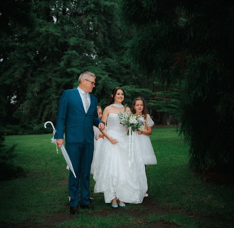 Bride walking with family before the outdoor wedding ceremony in Adelaide