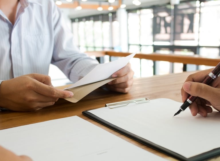 lawyer writing and meeting with client