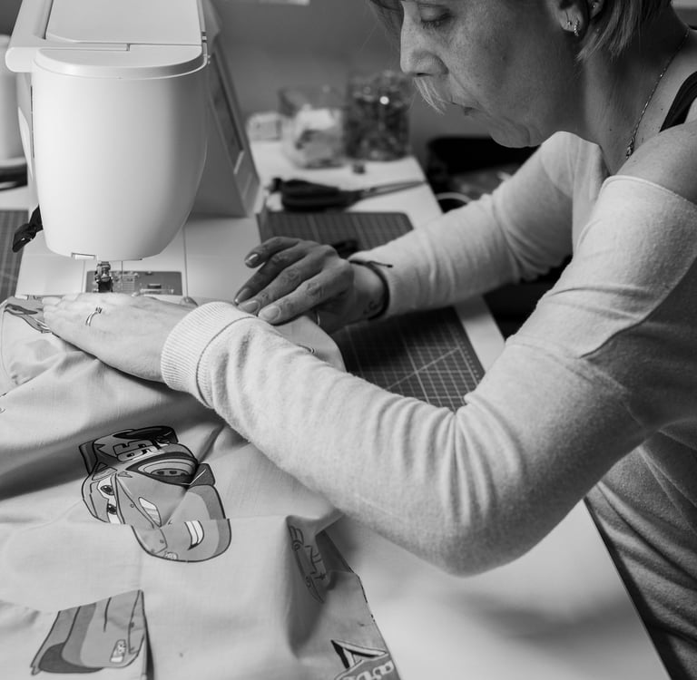 a woman is sewing an accessory on a sewing machine