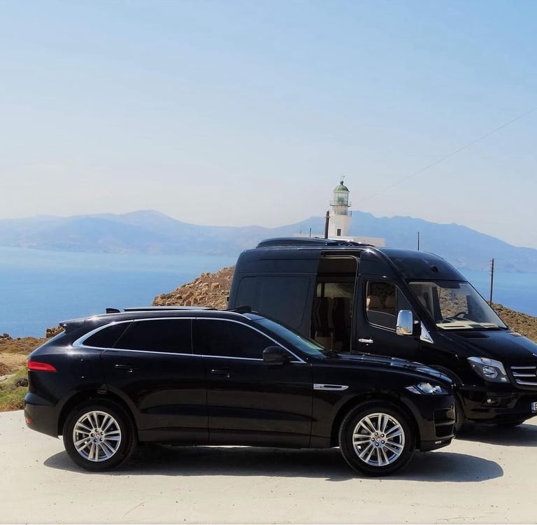 a van parked on a hill with a lighthouse in the background