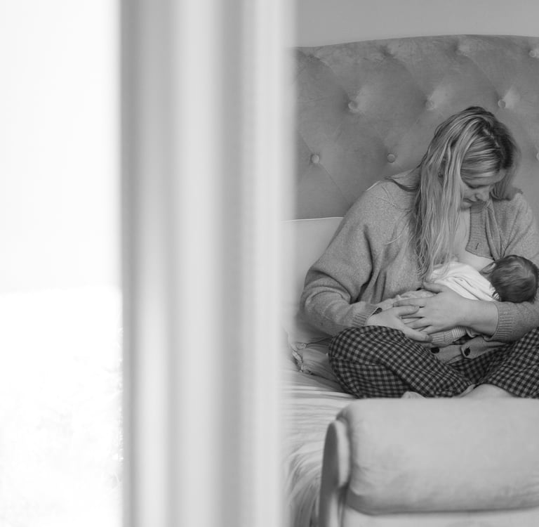 Mother holding her baby during an indoor photoshoot in Brighton.