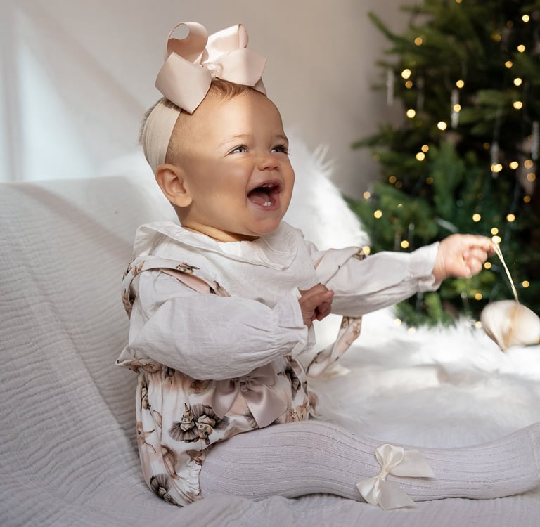 Smiling baby portrait captured during a Christmas family photography session.