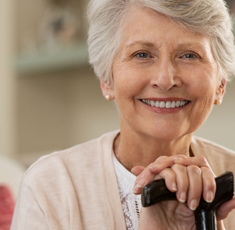 A smiling woman with dentures.