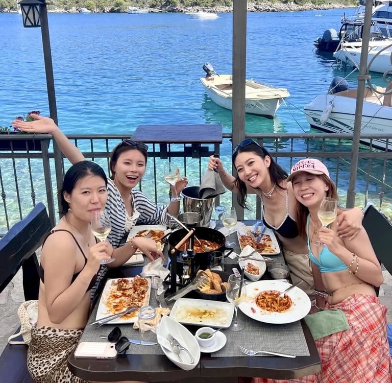 Girls enjoying seaside lunch in Sesula restaurant on Solta island during private boat trip from Split